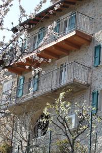 a building with a balcony on the side of it at Casa Rustica - Appartamenti Pilati in Tremosine Sul Garda
