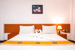 Postel nebo postele na pokoji v ubytování Neptuna Hotel