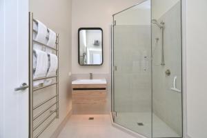 a bathroom with a glass shower and a sink at Kaiapoi Luxury Accommodation 2 - Bookahome in Kaiapoi