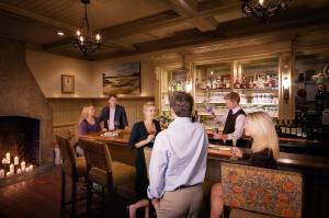 a group of people standing around a bar at Wentworth Mansion in Charleston