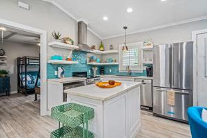 a kitchen with white cabinets and stainless steel appliances at Sangria Sunset in Rockport