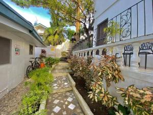 une passerelle menant à un bâtiment avec des plantes dans l'établissement Balay sa bukid (1bedroom), à Boracay