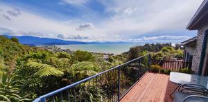 a balcony of a house with a view of the ocean at Beau Vista Pohara in Pohara