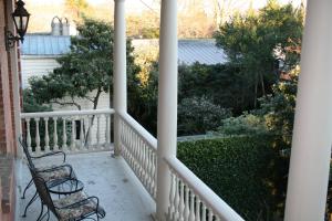 a porch with two chairs and a view of a garden at Wentworth Mansion in Charleston