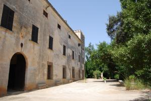 a person standing in front of a building at Finca Son Vivot in Inca