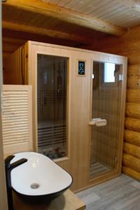a bathroom with a sink and a glass shower at Magura little chalet in Măgura