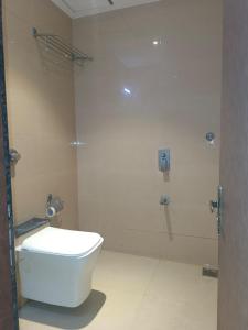 a bathroom with a toilet and a shower at Hotel West INN-Near Mumbai International Airport in Mumbai