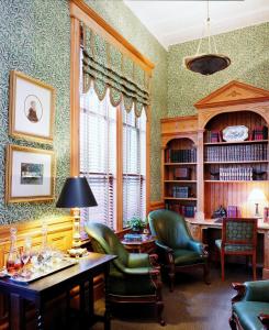 a living room with a table and chairs and a window at Wentworth Mansion in Charleston