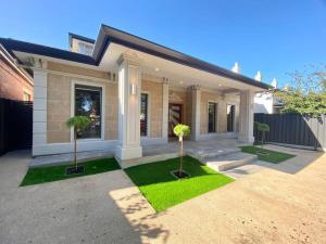 a house with two trees in front of it at New Spacious Luxury 5 Bedroom Mansion in Unley in Unley