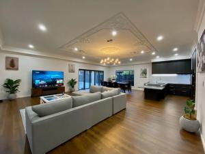 a large living room with a couch and a table at New Spacious Luxury 5 Bedroom Mansion in Unley in Unley