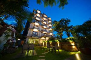 a hotel at night with chairs in front of it at Kumari Star Inn in Pokhara