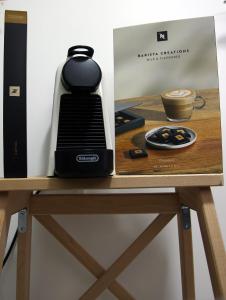 a coffee maker on a table next to a box at The Summer Lakeside Room in North Lakes
