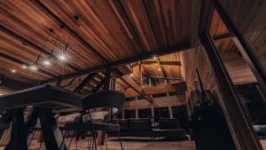 a room with chairs and a piano in a building at Hygge Chalet Hakuba in Hakuba