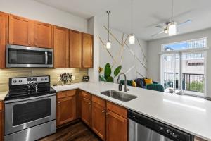 a kitchen with a stove and a sink at Luxury Apartment with KING BED and POOL and FREE PARKING 4 in Houston