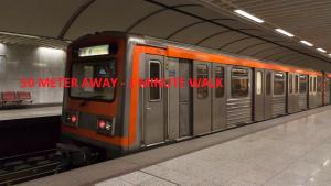 a subway train on the tracks in a subway station at Hotel Cosmos in Athens