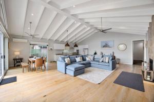 uma sala de estar com um sofá azul e uma mesa em Live the Luxury Lifestyle in Lohr em Inverloch