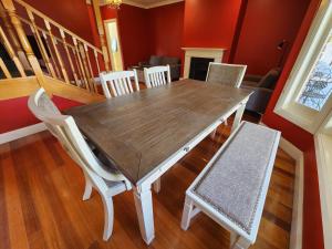 a dining room with a wooden table and chairs at Lady Heleena's At Strahan in Strahan