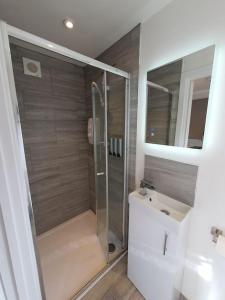 a bathroom with a shower and a sink at The Tiny Sea Gem in Jaywick Sands