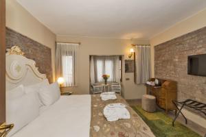 a hotel room with a bed and a tv at By Murat Royal Hotel Galata in Istanbul
