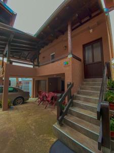 a house with stairs and a table and chairs at Kuća za odmor CAR - Tekija in Tekija