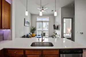 a kitchen with a sink and a living room at Downtown Houston Condo w Pool and Free Parking 6 in Houston