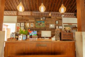 a wooden counter with a computer on top of it at Alam Puisi Villa Ubud in Ubud