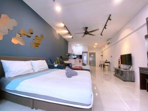 a bedroom with a bed and a living room at Mercu Summer Suites Bernice KLCC in Kuala Lumpur