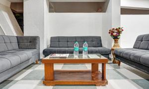 two water bottles on a coffee table in a living room at Treebo Trend Tulip in Pune