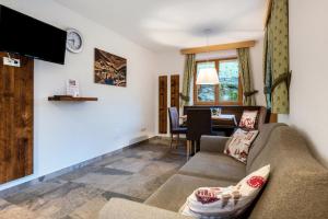 a living room with a couch and a table at Alpenappart App Schwarzenstein in Cadipietra