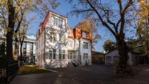 a white house with a tree in front of it at N48 Boutique Hotel in Tallinn