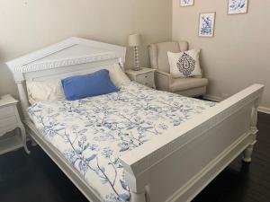 a bedroom with a white bed and a chair at Wellington Bondi Beach in Sydney