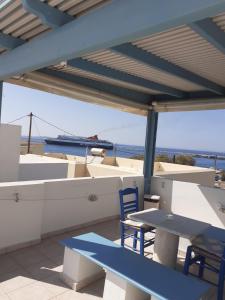 a table and chairs on a patio with a view of the ocean at Katy's Home in Naxos Chora