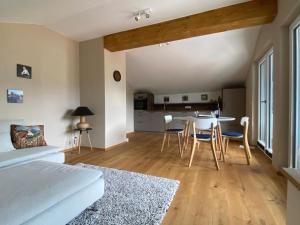 a room with a bed and a table and chairs at Ferienwohnung Panorama inkl. Chiemgaukarte in Ruhpolding