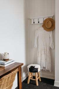 a white dress and a stool in a room at Anchor Geelong in Geelong