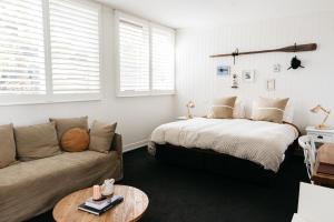 a bedroom with a bed and a couch at Anchor Geelong in Geelong