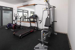 a gym with several tread machines in a room at Aparthotel Punta Blu in Premantura