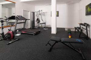 a gym with several exercise equipment in a room at Aparthotel Punta Blu in Premantura
