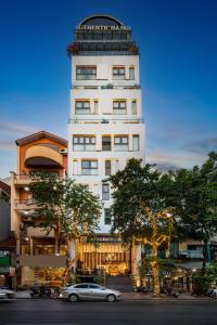 a building with a car parked in front of it at Authentic Hanoi Boutique Hotel in Hanoi