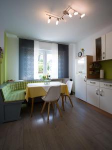 a kitchen and dining room with a yellow table and chairs at Ferienwohnung Grete in Merzig