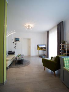 a living room with a couch and a table at Ferienwohnung Grete in Merzig