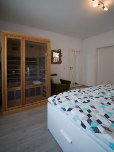 a bedroom with a bed and a sliding glass door at Ferienwohnung Grete in Merzig