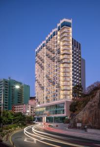 a tall building with a street in front of it at Grab The Ocean Songdo in Busan