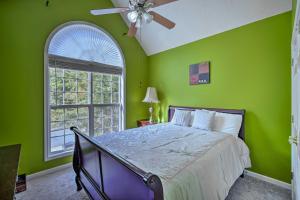 Dormitorio verde con cama y ventana en Spacious Acworth Home with Deck about 1 Mi to Lake, en Acworth