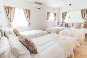 Bijou Suites Sorriso - Vacation STAY 82795 tesisinde bir odada yatak veya yataklar