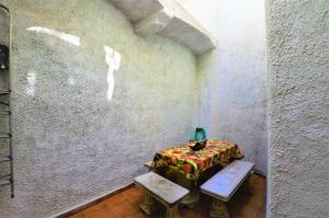 a room with a table and two benches next to a wall at LUXURY HOUSE 8 PERSONS FRONT THE BEACH BLANES COSTA BRAVA in Blanes