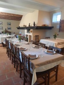 a dining room with tables and chairs in a room at Agriturismo IL FRA' in Tigliole