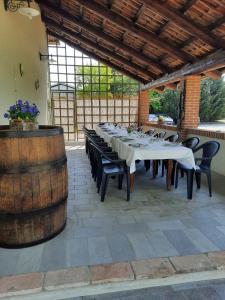 comedor grande con mesa y barril en Agriturismo IL FRA', en Tigliole