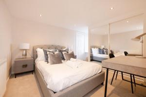 a bedroom with a large bed and a living room at JOIVY Stylish flat near Perth Museum in Perth