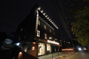 a building with lights on top of it at night at Southern Residency in Cochin