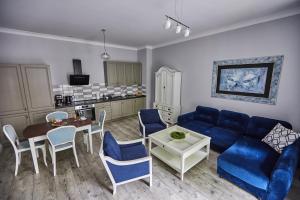 un soggiorno con divano blu e tavolo di Niebieski Apartament DE LUX dla 4 osób Chorzów Katowice a Chorzów